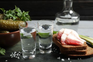 Photo of Cold Russian vodka with snacks on wooden table