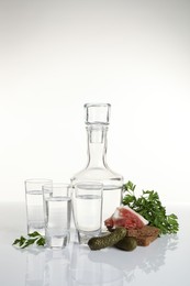 Photo of Russian vodka and different appetizers isolated on white