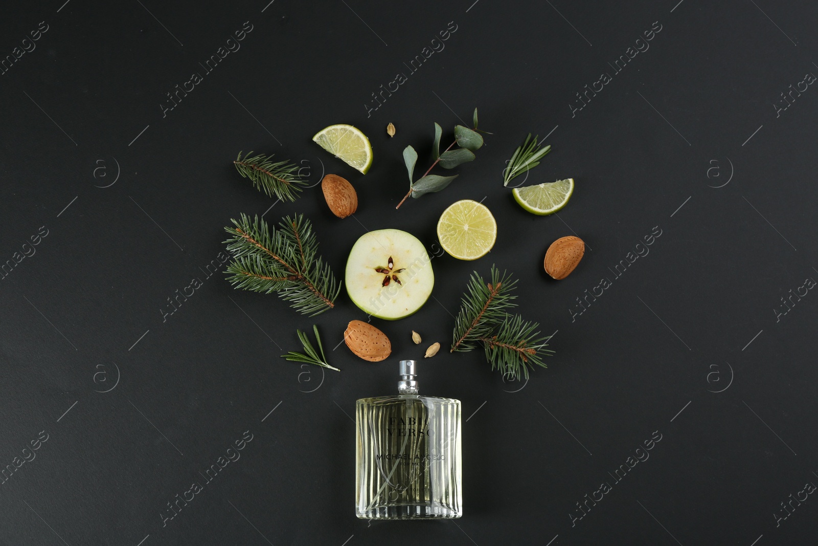 Flat lay composition with bottle of perfume on black background Photo of Flat lay composition with bottle of perfume on black background