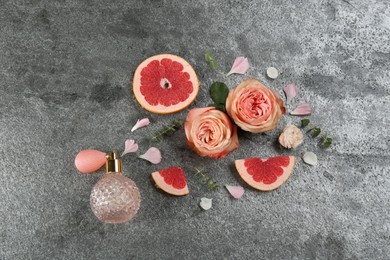 Photo of Flat lay composition with bottle of perfume on grey background