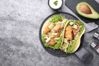 Photo of Delicious fish tacos served on grey table, flat lay with space for text