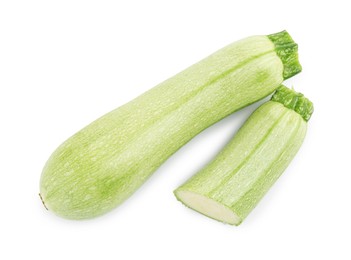 Photo of Fresh whole and cut zucchinis isolated on white, top view