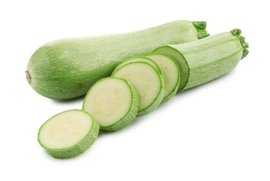 Photo of Fresh whole and cut zucchinis isolated on white