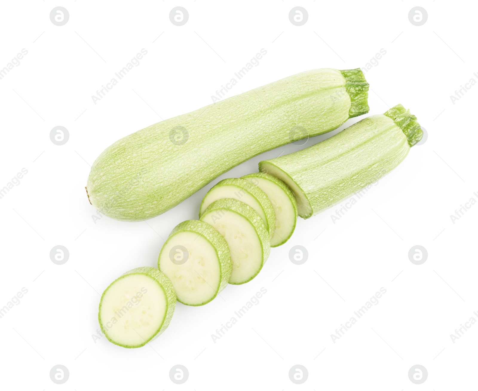 Photo of Fresh whole and cut zucchinis isolated on white, top view