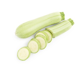 Photo of Fresh whole and cut zucchinis isolated on white, top view