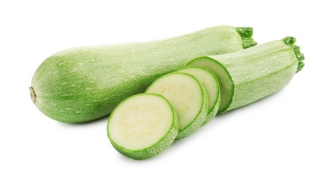 Photo of Fresh whole and cut zucchinis isolated on white