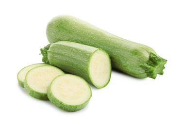 Photo of Fresh whole and cut zucchinis isolated on white