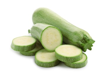 Photo of Fresh whole and cut zucchinis isolated on white