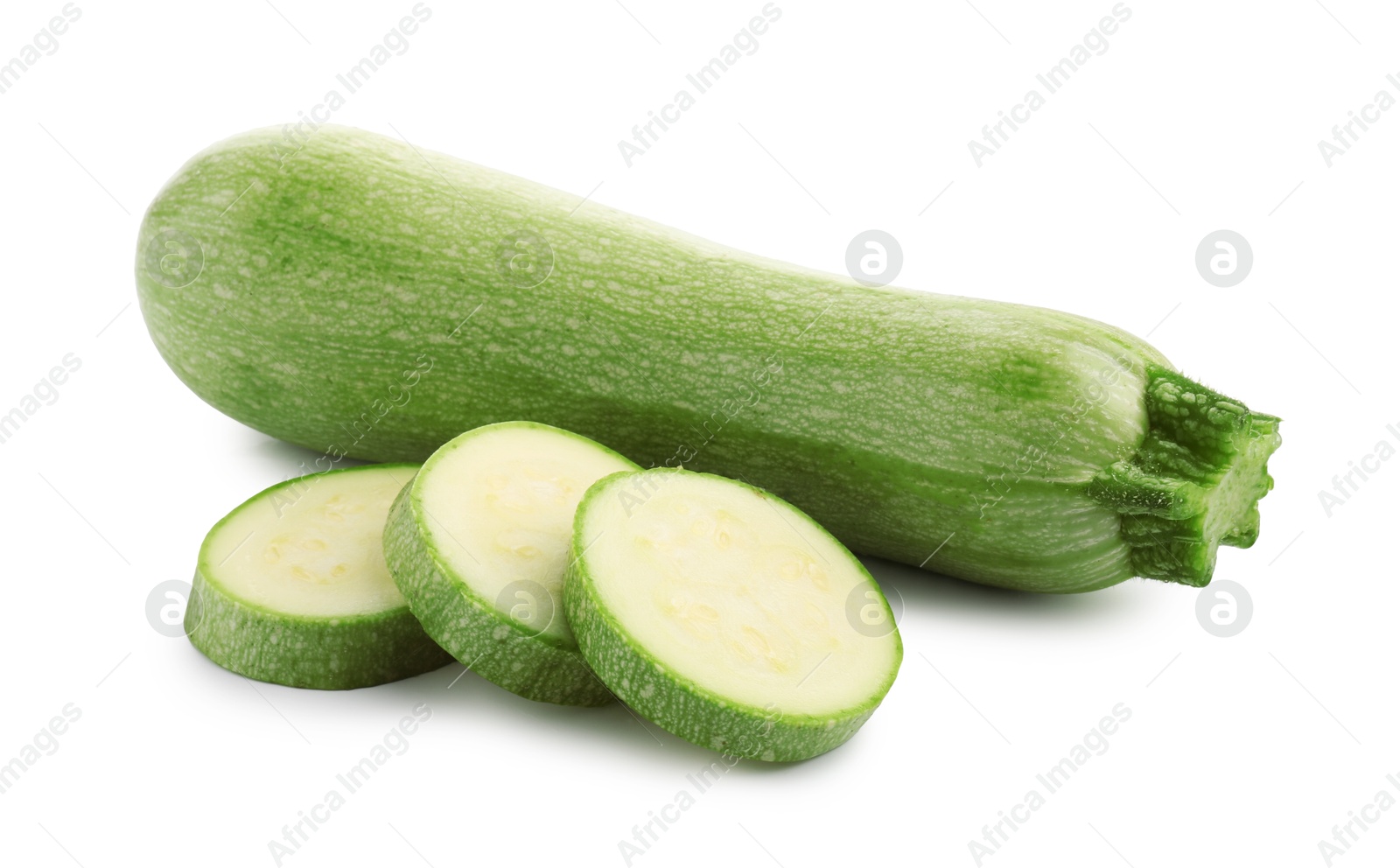 Photo of Fresh whole and cut zucchinis isolated on white