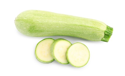 Photo of Fresh whole and cut zucchinis isolated on white, top view
