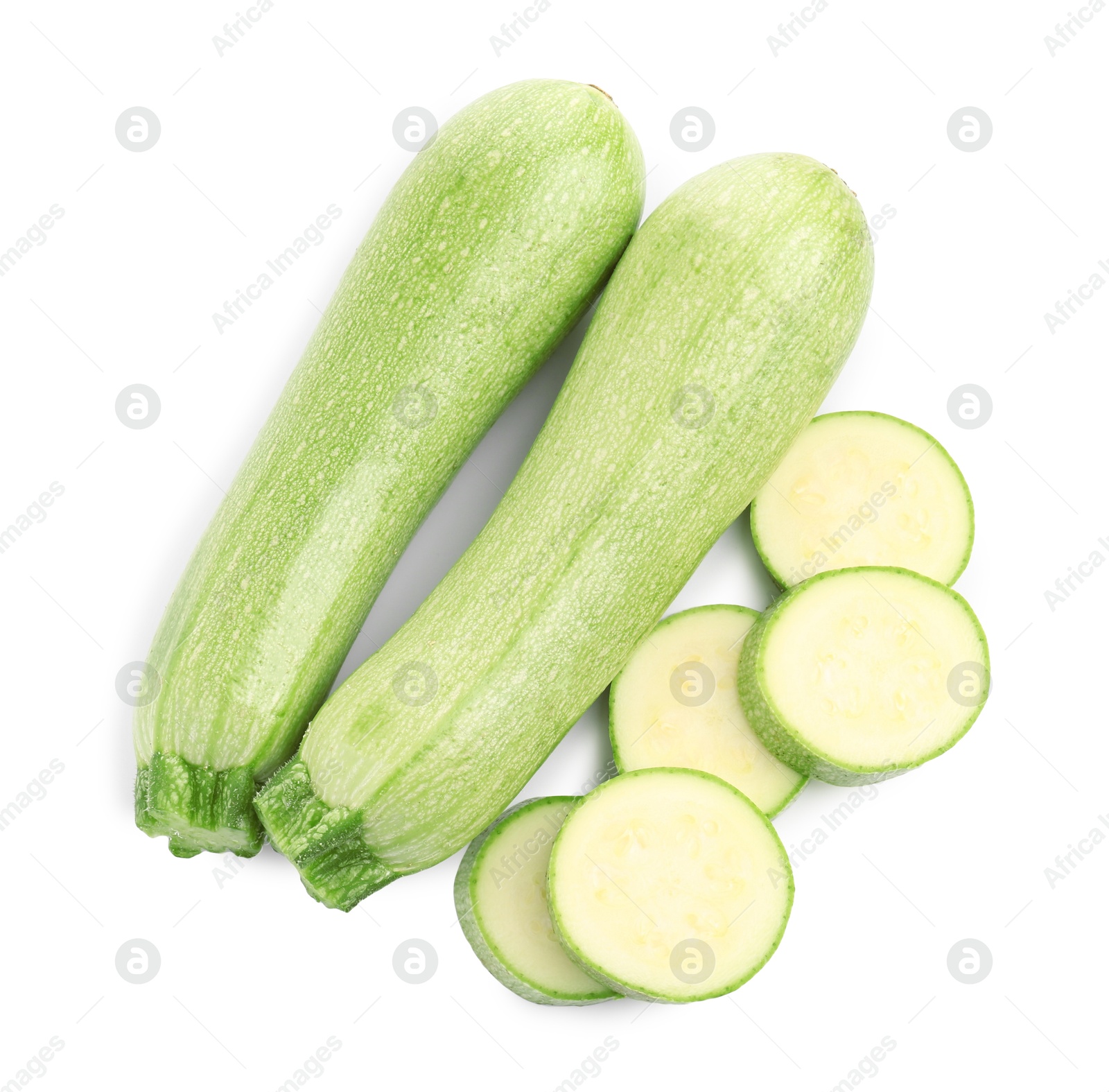 Photo of Fresh whole and cut zucchinis isolated on white, top view
