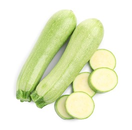 Photo of Fresh whole and cut zucchinis isolated on white, top view