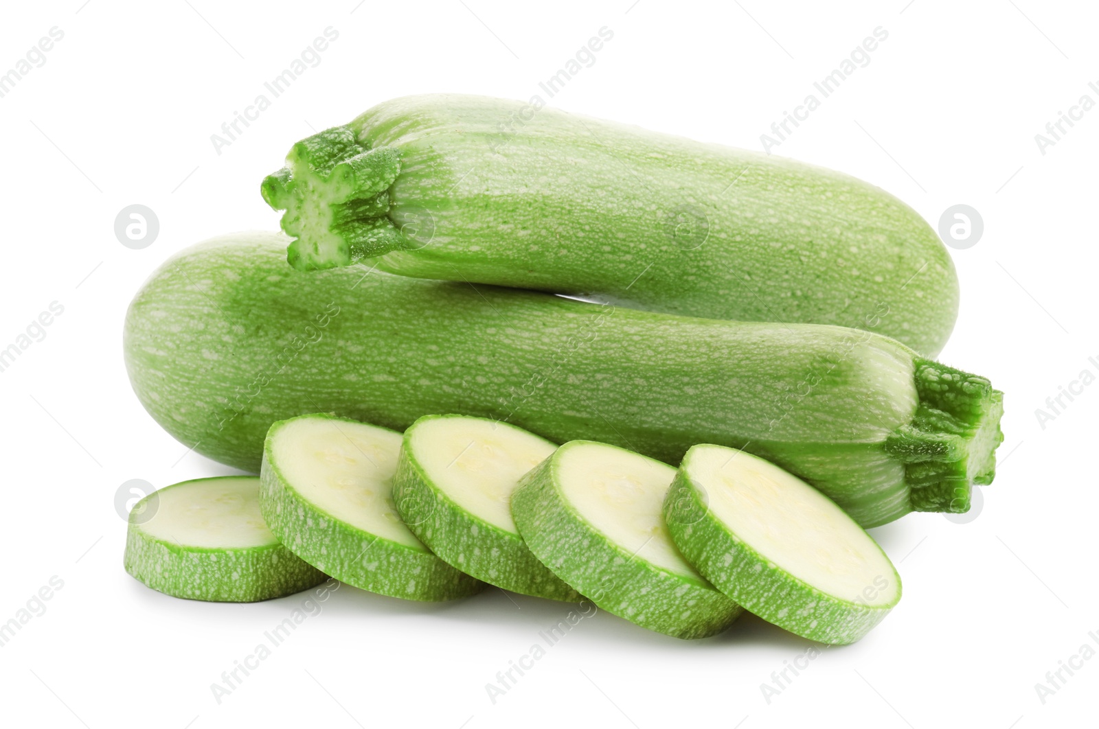 Photo of Fresh whole and cut zucchinis isolated on white
