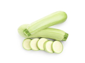 Photo of Fresh whole and cut zucchinis isolated on white, top view