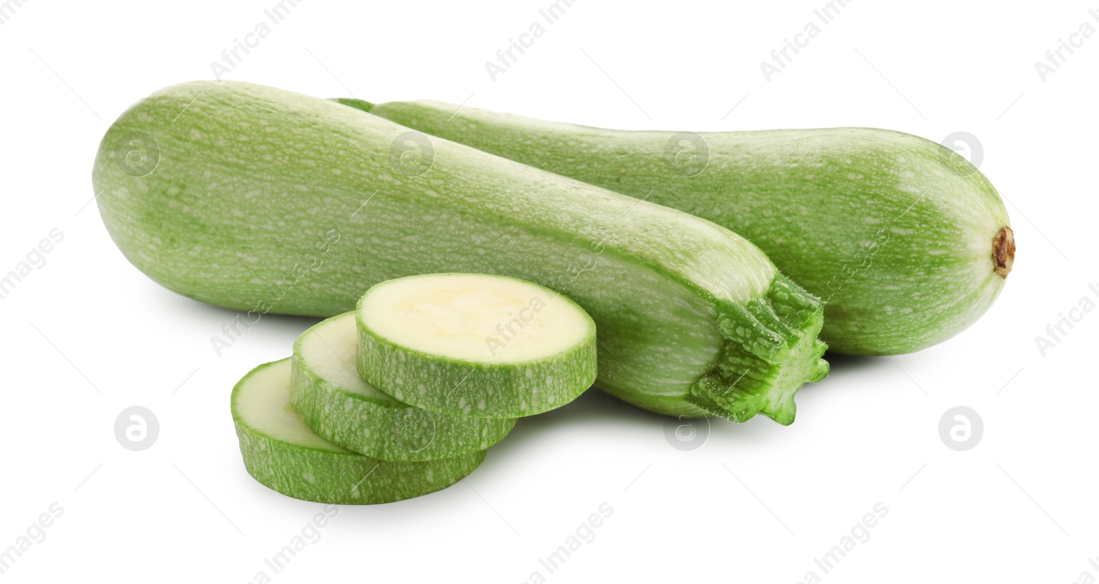 Photo of Fresh whole and cut zucchinis isolated on white