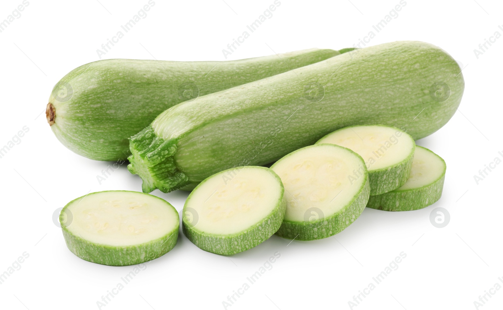 Photo of Fresh whole and cut zucchinis isolated on white