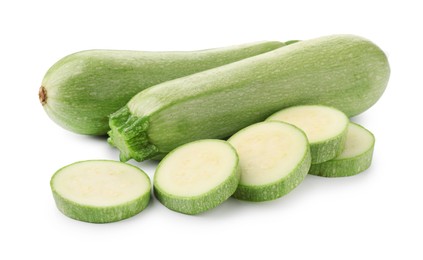 Photo of Fresh whole and cut zucchinis isolated on white