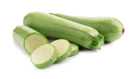 Photo of Fresh whole and cut zucchinis isolated on white