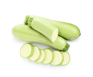 Photo of Fresh whole and cut zucchinis isolated on white, top view