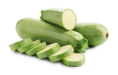 Photo of Fresh whole and cut zucchinis isolated on white