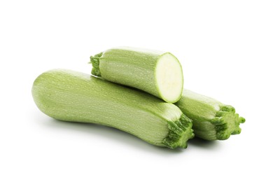 Photo of Fresh whole and cut zucchinis isolated on white