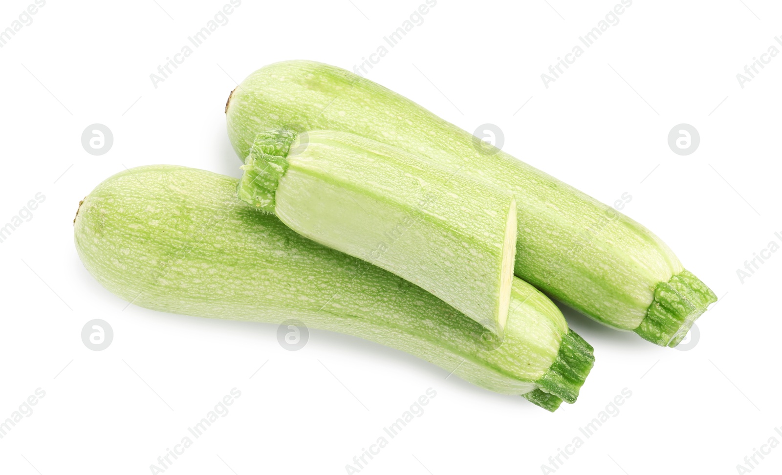 Photo of Fresh whole and cut zucchinis isolated on white, top view