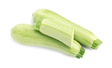Photo of Fresh whole and cut zucchinis isolated on white, top view