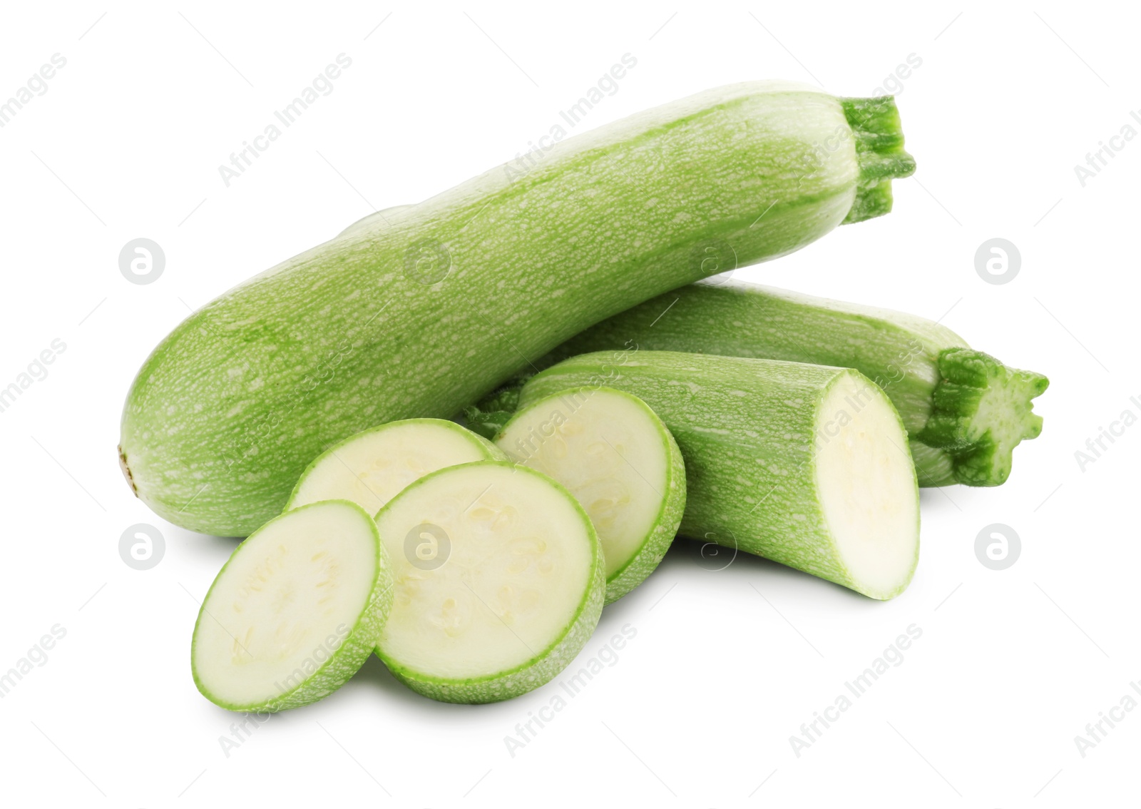 Photo of Fresh whole and cut zucchinis isolated on white