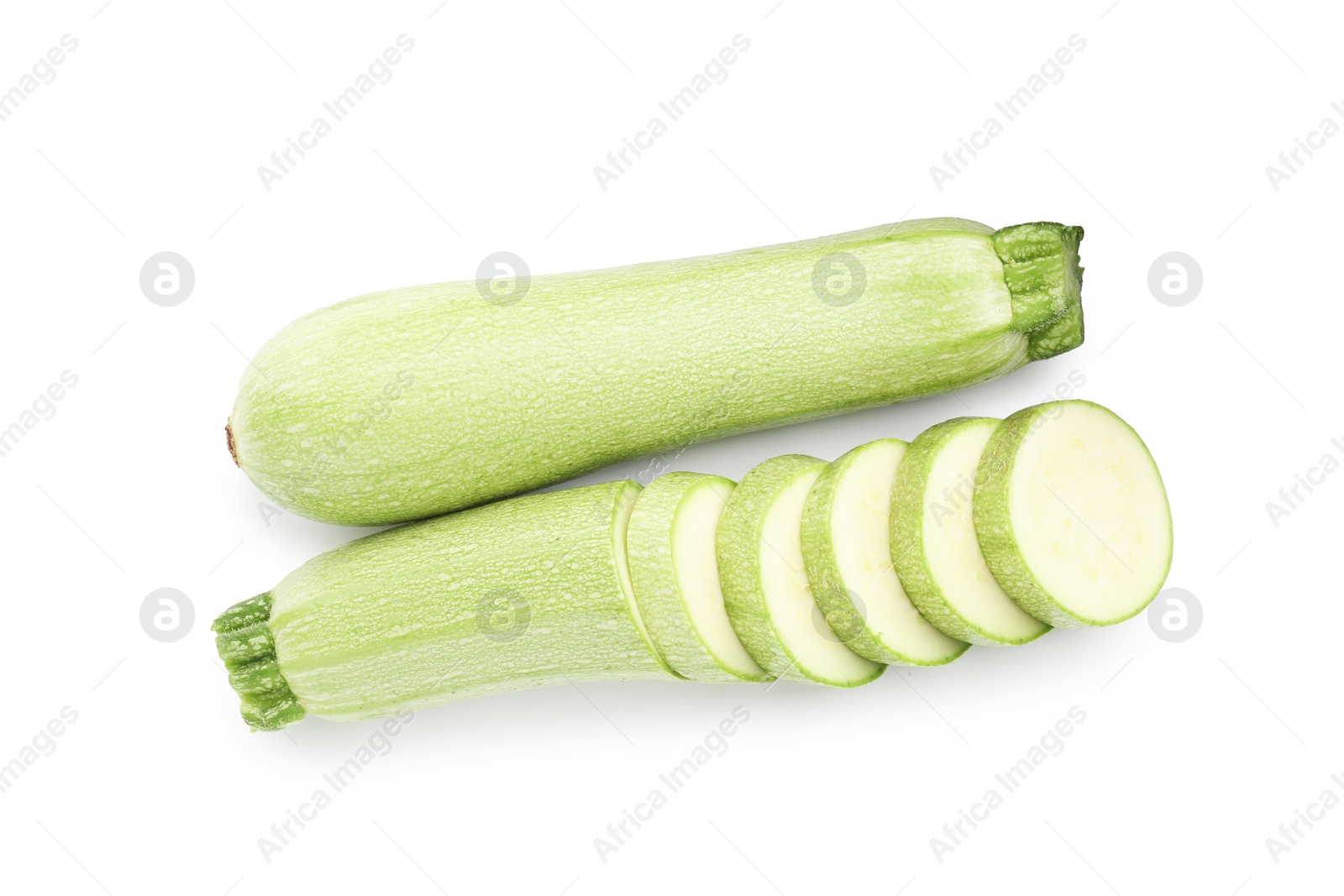 Photo of Fresh whole and cut zucchinis isolated on white, top view