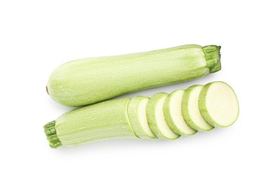 Photo of Fresh whole and cut zucchinis isolated on white, top view