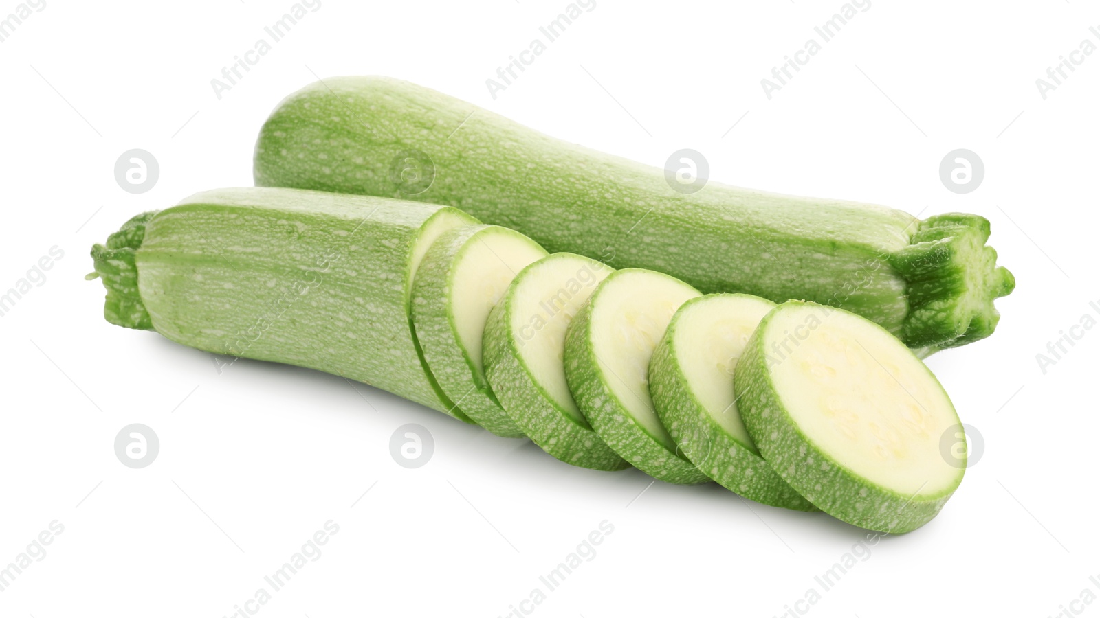 Photo of Fresh whole and cut zucchinis isolated on white