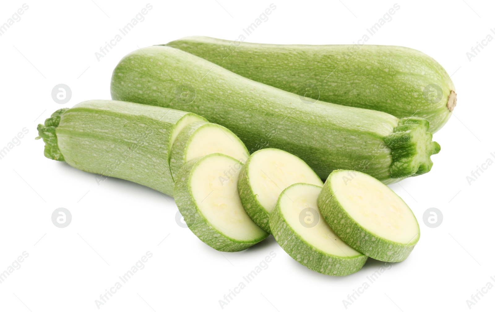 Photo of Fresh whole and cut zucchinis isolated on white