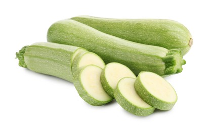 Photo of Fresh whole and cut zucchinis isolated on white