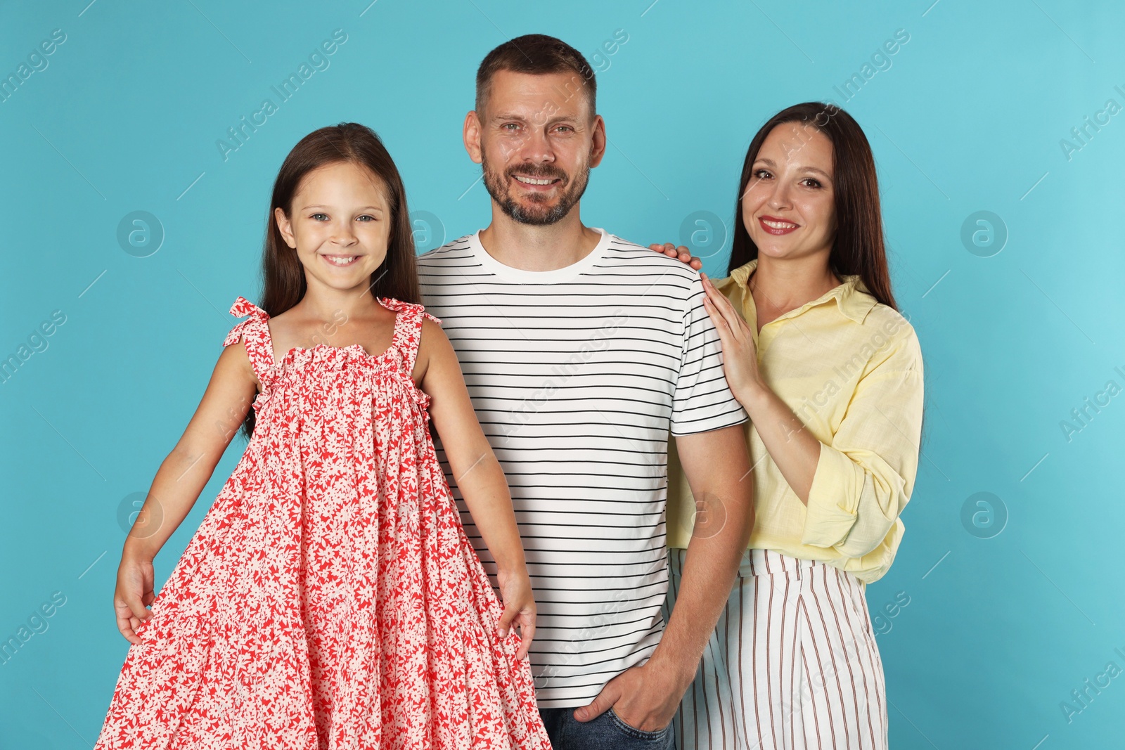 Photo of Portrait of happy family on light blue background