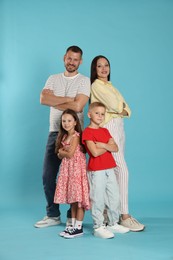 Photo of Lovely family posing together on light blue background