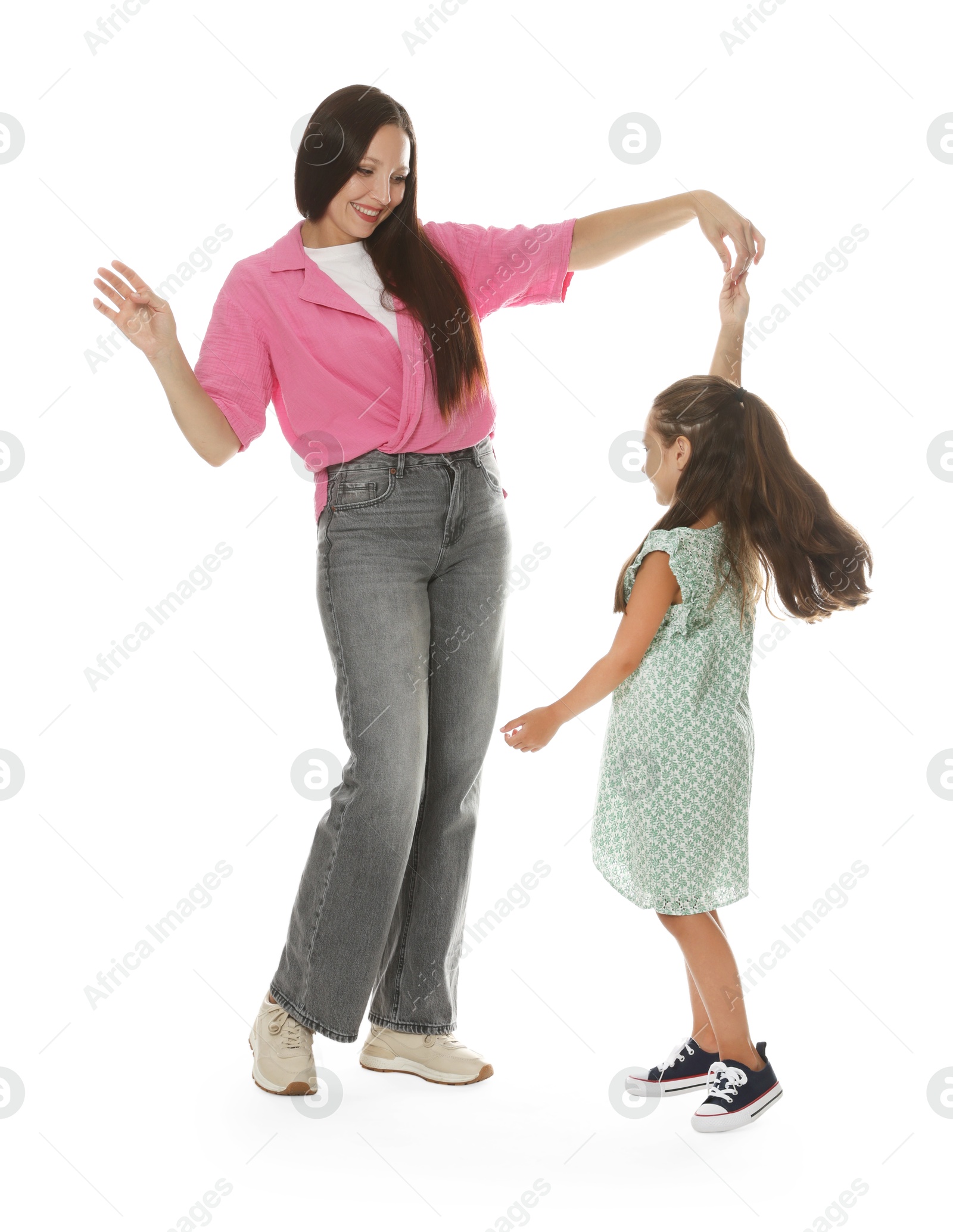 Photo of Happy mother and daughter dancing on white background