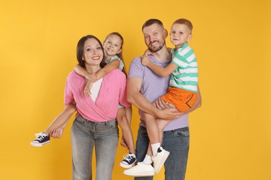 Photo of Portrait of happy family on yellow background