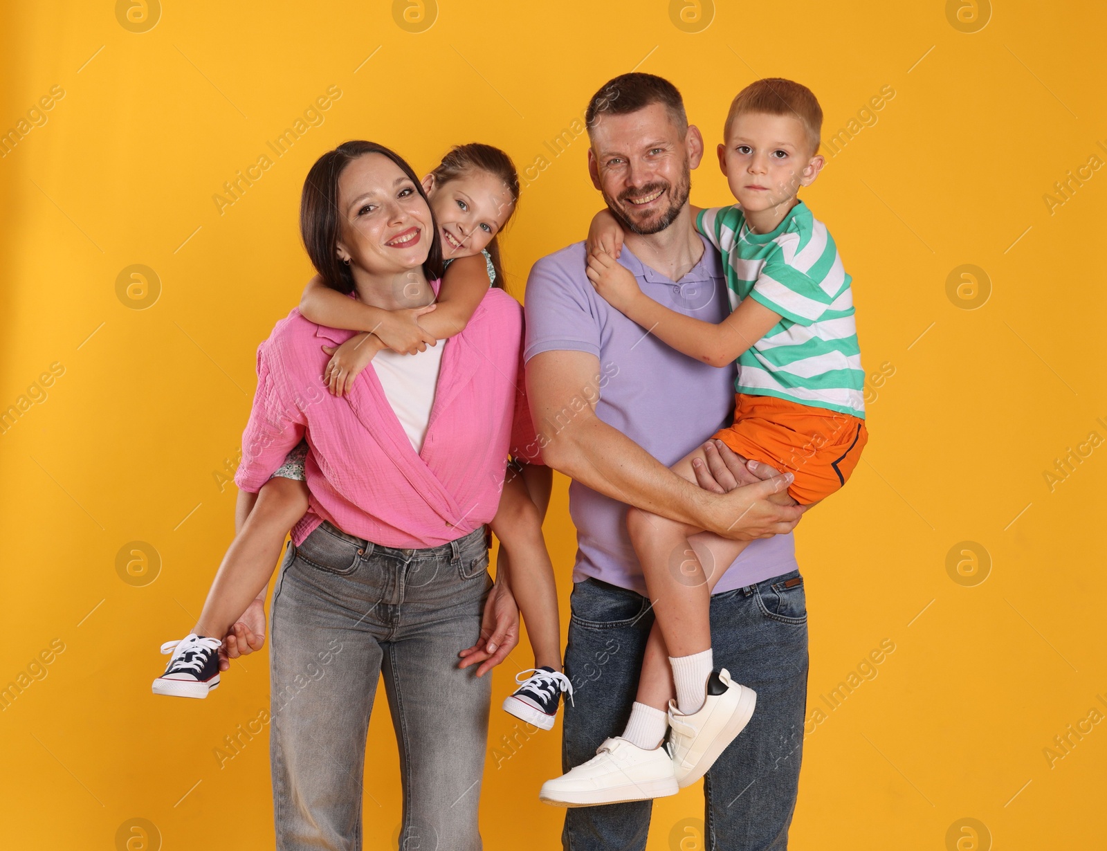 Photo of Portrait of happy family on yellow background