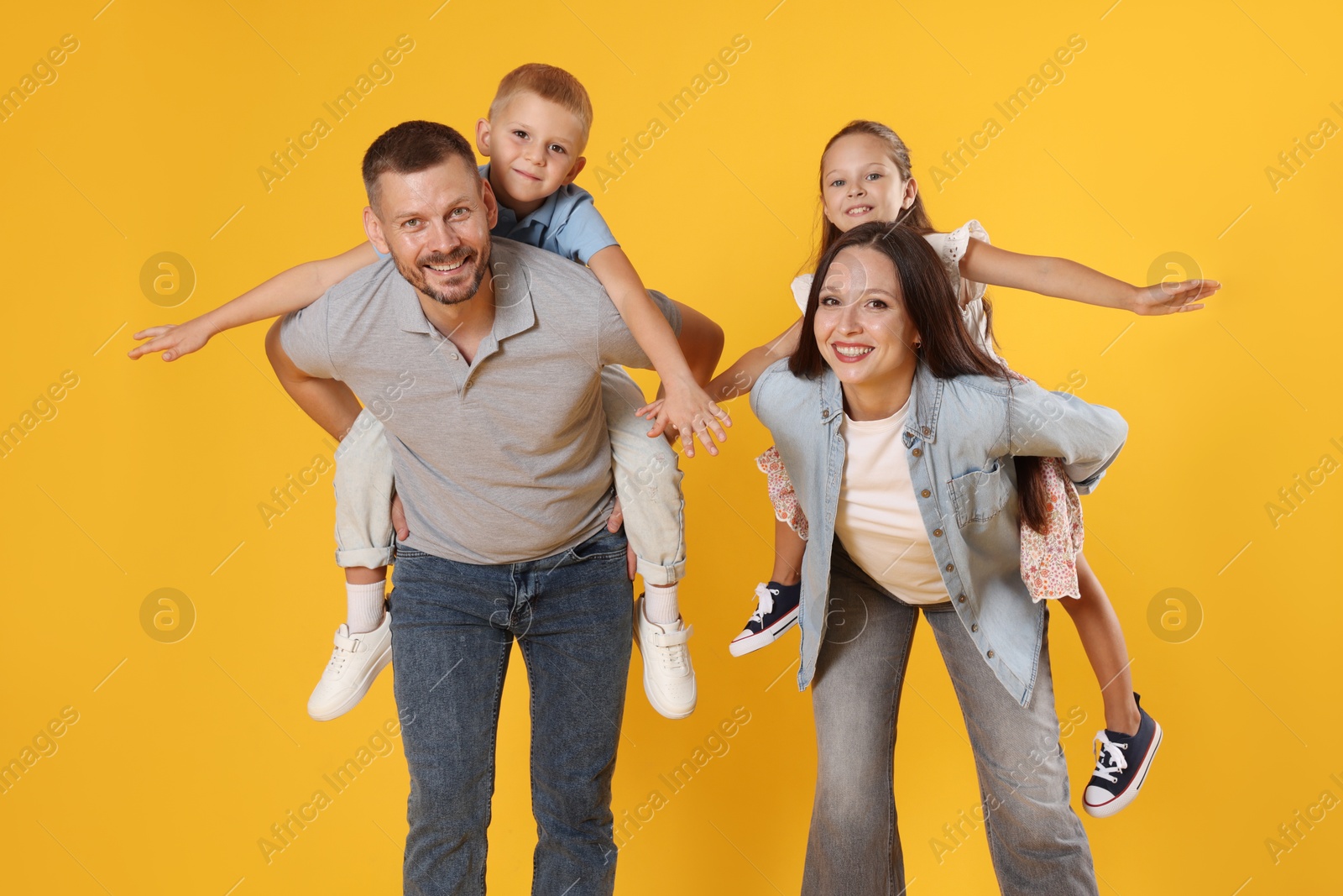 Photo of Happy family having fun on yellow background