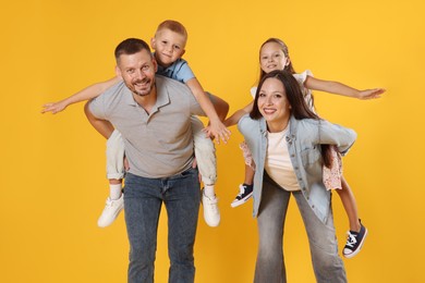 Photo of Happy family having fun on yellow background