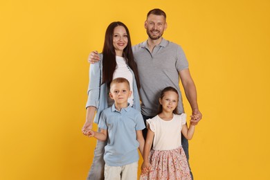 Photo of Portrait of happy family on yellow background