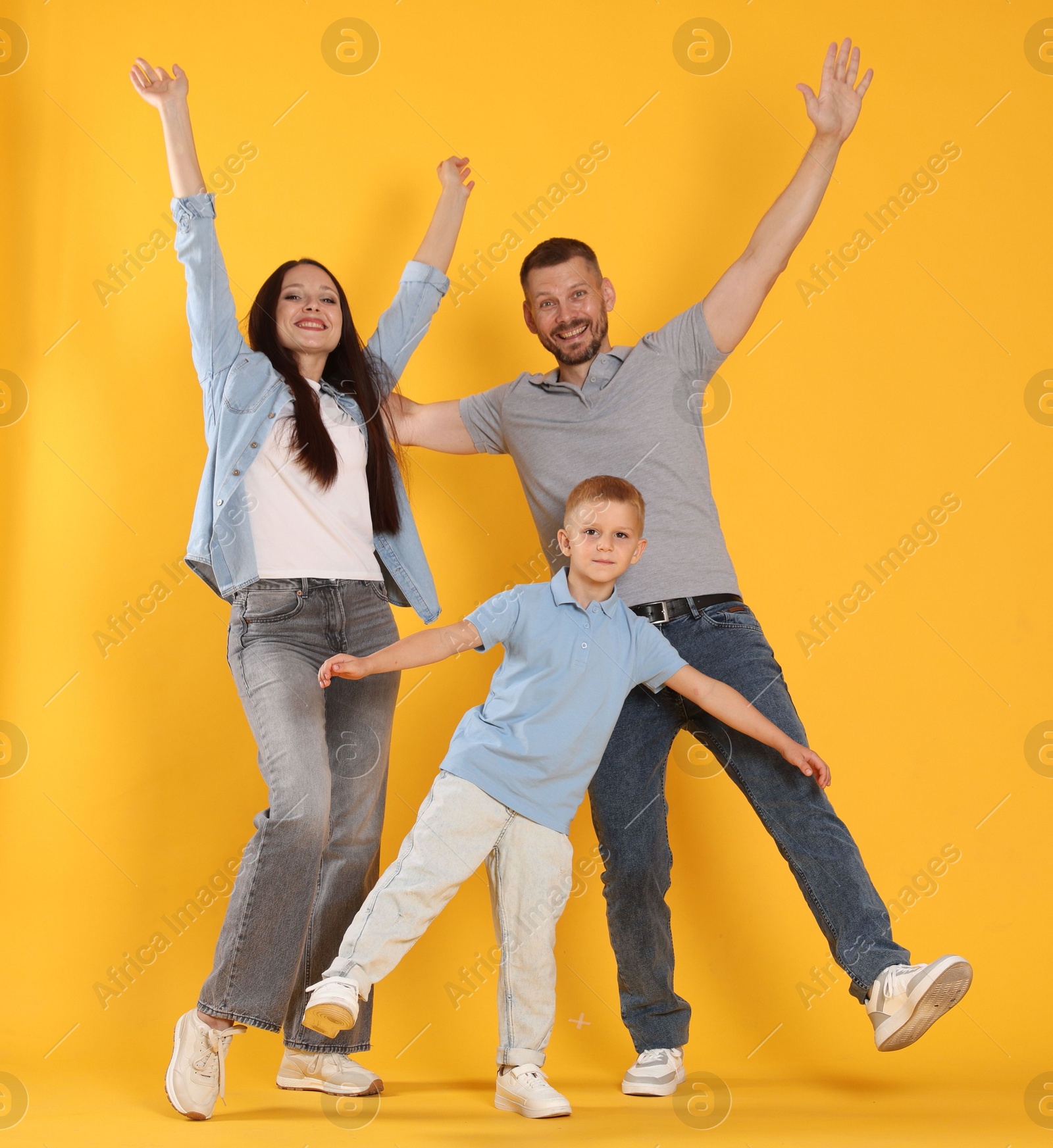 Photo of Happy family having fun on yellow background