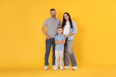 Photo of Lovely family posing together on yellow background