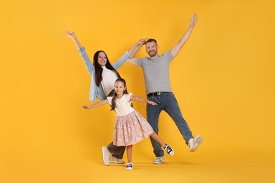 Photo of Happy family having fun on yellow background