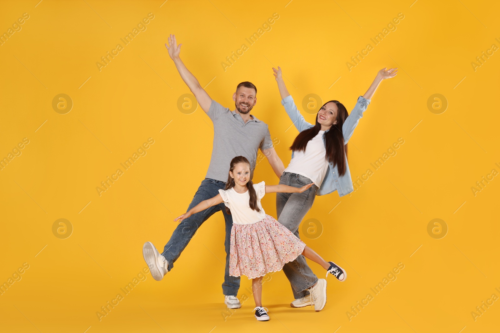 Photo of Happy family having fun on yellow background