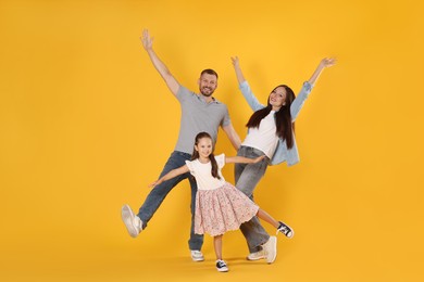 Photo of Happy family having fun on yellow background