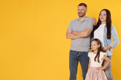 Photo of Portrait of happy family on yellow background. Space for text