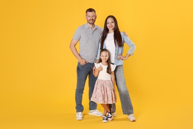 Photo of Lovely family posing together on yellow background
