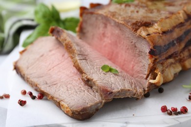 Photo of Delicious baked beef meat and spices on table, closeup