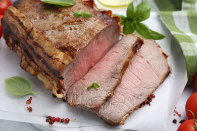 Photo of Delicious baked beef meat and spices on table, closeup